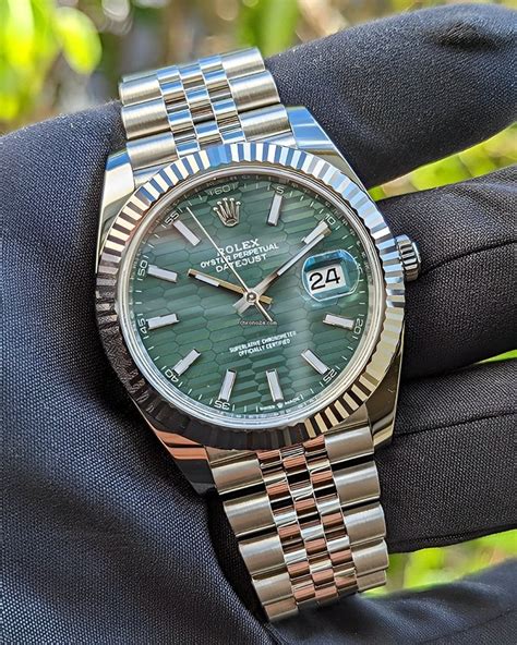 silver Rolex with green face